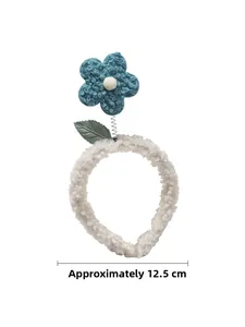 Detail view of cute floral headband with soft fleece texture and a spring flower element
