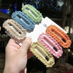 Detail of 6 colorful handmade crochet hair clips set on a card with Sweet Girl text