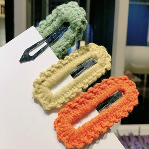 Set of three colorful handmade crochet BB hair clips in green, yellow, and orange knit