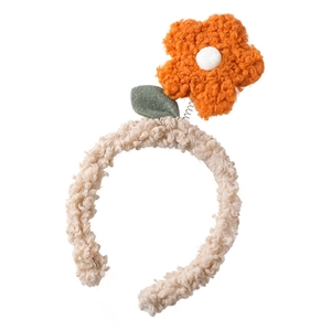Cute plush beige headband featuring a 3D orange flower on spring with a green leaf