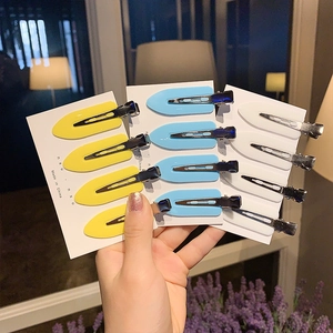 Set of 12 seamless plastic duckbill hair clips in yellow blue and white on paper card