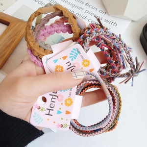 Close-up of high elasticity colorful braided hair bands in a floral gift packaging