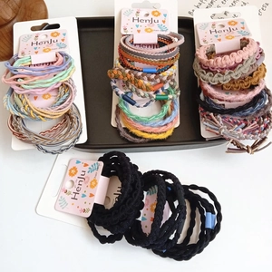Detail view of assorted colorful braided and ribbed hair bands on a display card