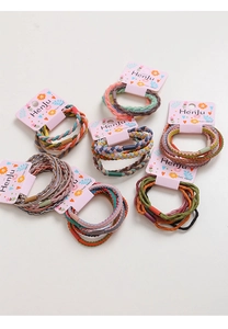 Close-up of colorful braided hair bands with elastic knit texture on pink cards
