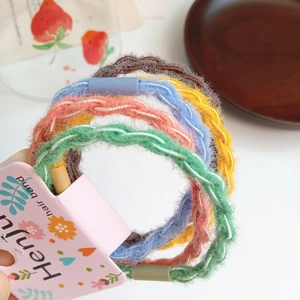 Detail of colorful plush braided hair ties with high elasticity in various pastel shades