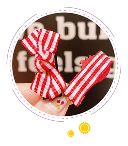 Close-up of red and white checkered bow hair clips for children handmade with cotton fabric