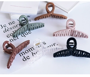 Detailed view of 6-piece large hair claws set in mixed colors on aesthetic background