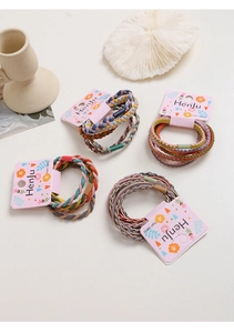 Detail showing the intricate braided texture and colorful elastic weave of the hair bands