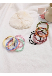 Detailed macro of multi-colored braided elastic hair ties with high elasticity texture