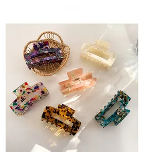 Detailed set of six large acetate hair claws in various marble and floral patterns