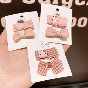 Set of cute cartoon bow hair clips and peach penguin accessories for young girls
