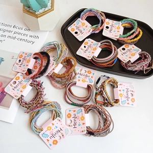 Colorful high elasticity braided hair ties set on decorative tray with brand packaging