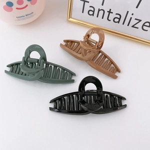 Three-piece minimalist glossy crisscross hair claw clips in green, beige, and black colors