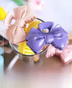 Close-up of candy-colored plastic bow hair claws in vibrant macaron shades for women