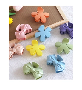 Matte finish macaron color flower and bow hair claw clips set on a wooden tray