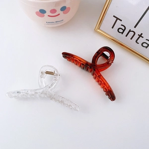 Minimalist large resin hair claws in transparent and amber colors for women