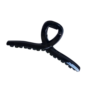 Classic glossy black hair claw clip with stylish wavy teeth design on white background