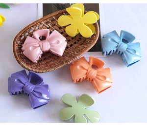Close-up of colorful flower and bow hair claws in vibrant candy colors and glossy finish