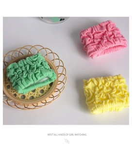 Detailed view of high-elasticity coral fleece hair ties in pink, green, and yellow colors