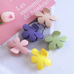 Set of five colorful matte floral hair claws in pastel pink, yellow, and green tones