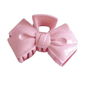 Sweet pink bow claw clip for women made of glossy plastic for elegant hair styling