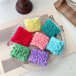 Set of 7 colorful bubble hair ties with elastic pleated texture on glass tray
