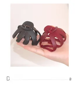 Large matte hair claws in black and burgundy with octopus design and strong metal spring