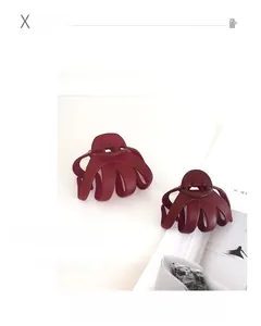Macro detail of wine red matte hair claw clips showing sturdy spring and octopus structure