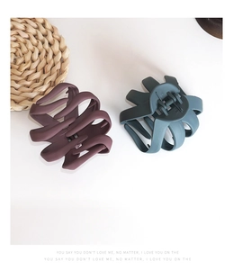 Matte finish octopus hair claws in deep plum and dark teal for thick hair styling