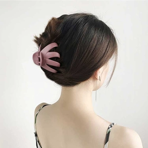 Matte mauve octopus claw clip for women holding a messy bun hair style securely