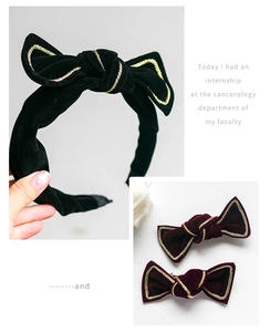 Detail of velvet bow headband and hairpins with elegant gold woven metallic edge trim