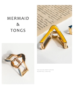Detailed view of V-shaped and wavy metal hair claws with colorful enamel finish