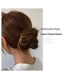 Minimalist gold U-shaped metal hair pin styled in an elegant updo bun hairstyle