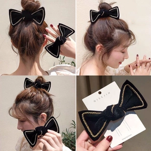 Elegant black velvet bow hair clip with gold chain trim in a vintage luxury aesthetic
