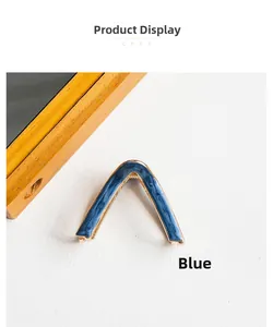 Detail shot of the V-shaped blue hair claw clip with gold metal trim and marble texture