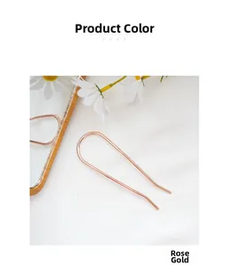 Detail view of the rose gold minimalist metal U-shaped hairpin for bun styling