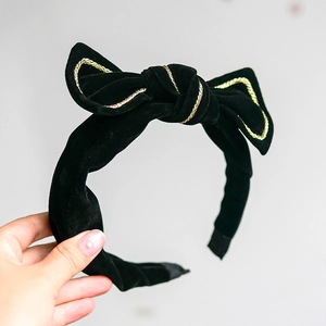 Elegant black velvet bow headband with golden braided trim for women minimalist hair style