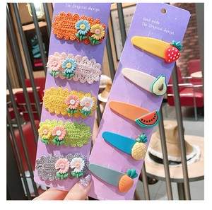 Close-up of 10-piece cute kids hair clips featuring woven flowers and cartoon fruit shapes