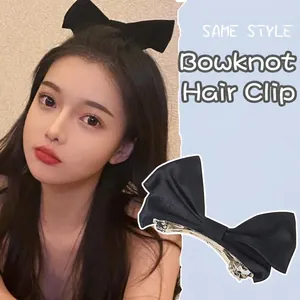 Elegant large black satin bow hair clip for women with premium metal clip attachment