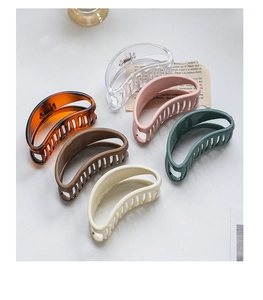 Flat lay of six colorful large claw clips in elegant shades with a smooth glossy finish