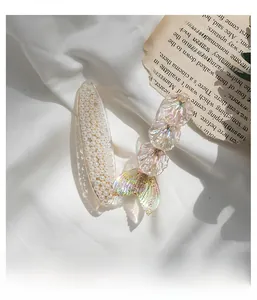 Detailed macro view of mermaid tail hair clip with pearls and shimmering glitter accents
