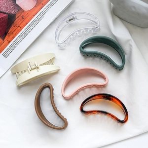 Set of 6 colorful minimalist large hair claws in various colors on white fabric background