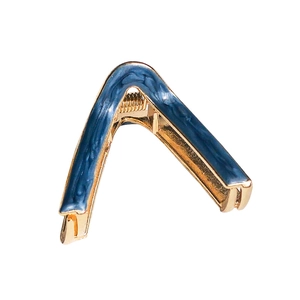 Elegant V-shaped gold metal hair claw with blue marble texture on a white background