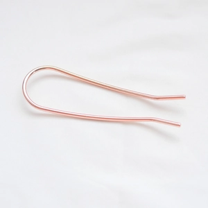 Minimalist U-shaped metal hair pin in rose gold finish with a polished surface