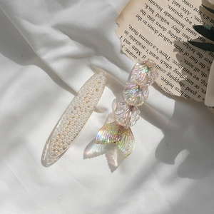 Mermaid tail and pearl hair clip set with iridescent scales on vintage book pages