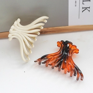 Large jellyfish-style hair claws in creamy white and amber gradient resin finishes