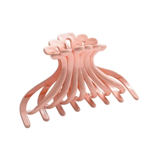 Glossy pale pink jellyfish hair claw clip with interlocking teeth on white background