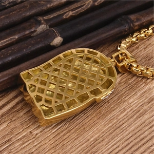 Gold hip hop cross pendant with honeycomb mesh back and box chain on wooden background