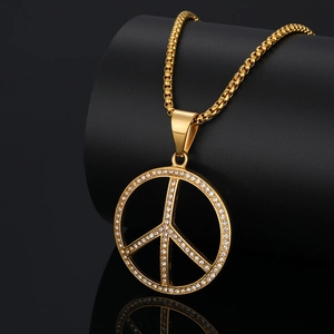 Iced out gold peace sign pendant necklace with cubic zirconia on black box chain