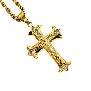 Classic gold cross pendant with crucifix and small white crystals on twisted chain